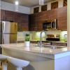 a kitchen with wooden cabinets and chairs
