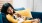 a person lying on a couch with a dog