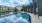 a pool in a courtyard with buildings in the background