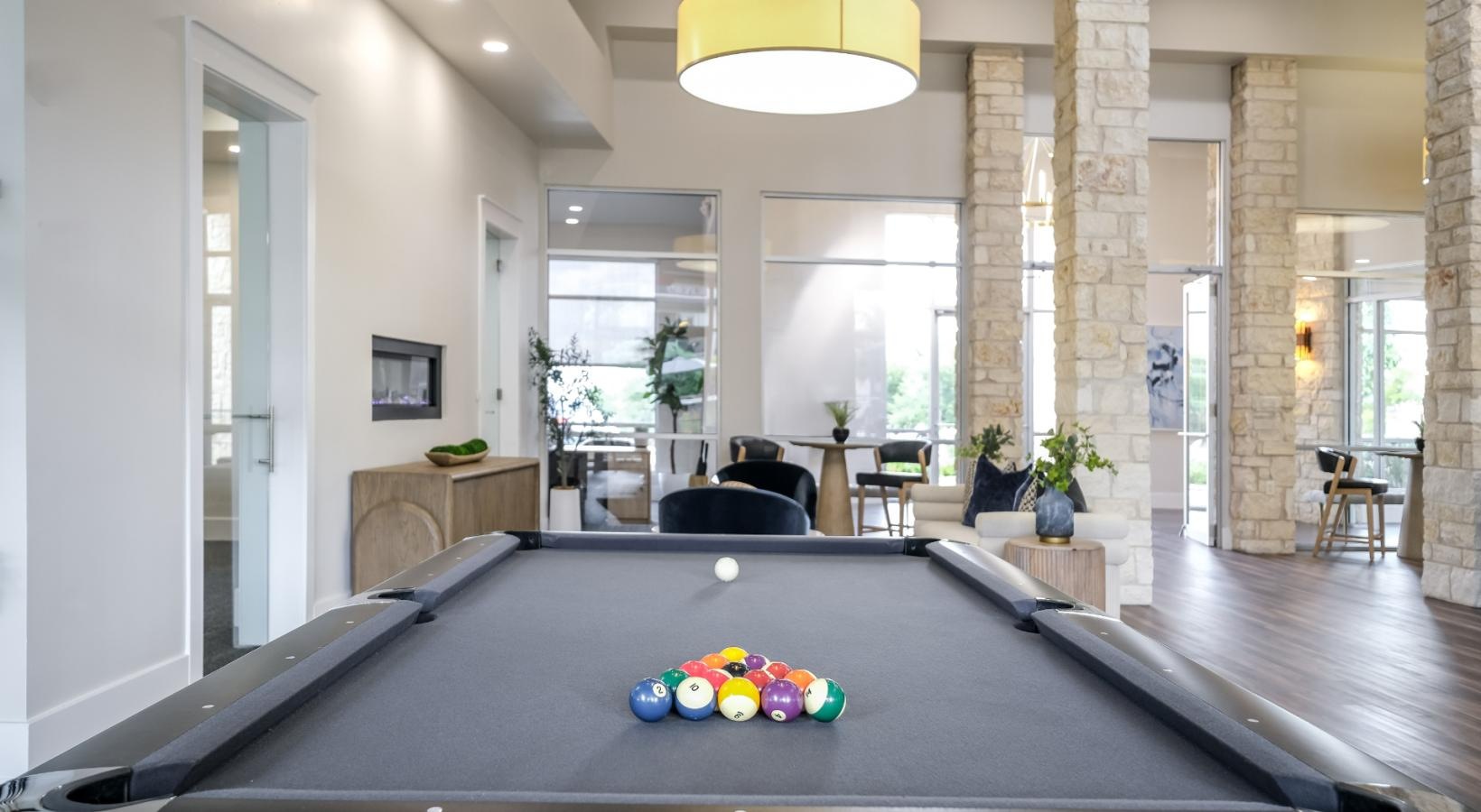 Find your perfect fit at The Allure a room with a pool table and chairs and a large window