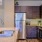 a kitchen with a stainless steel refrigerator