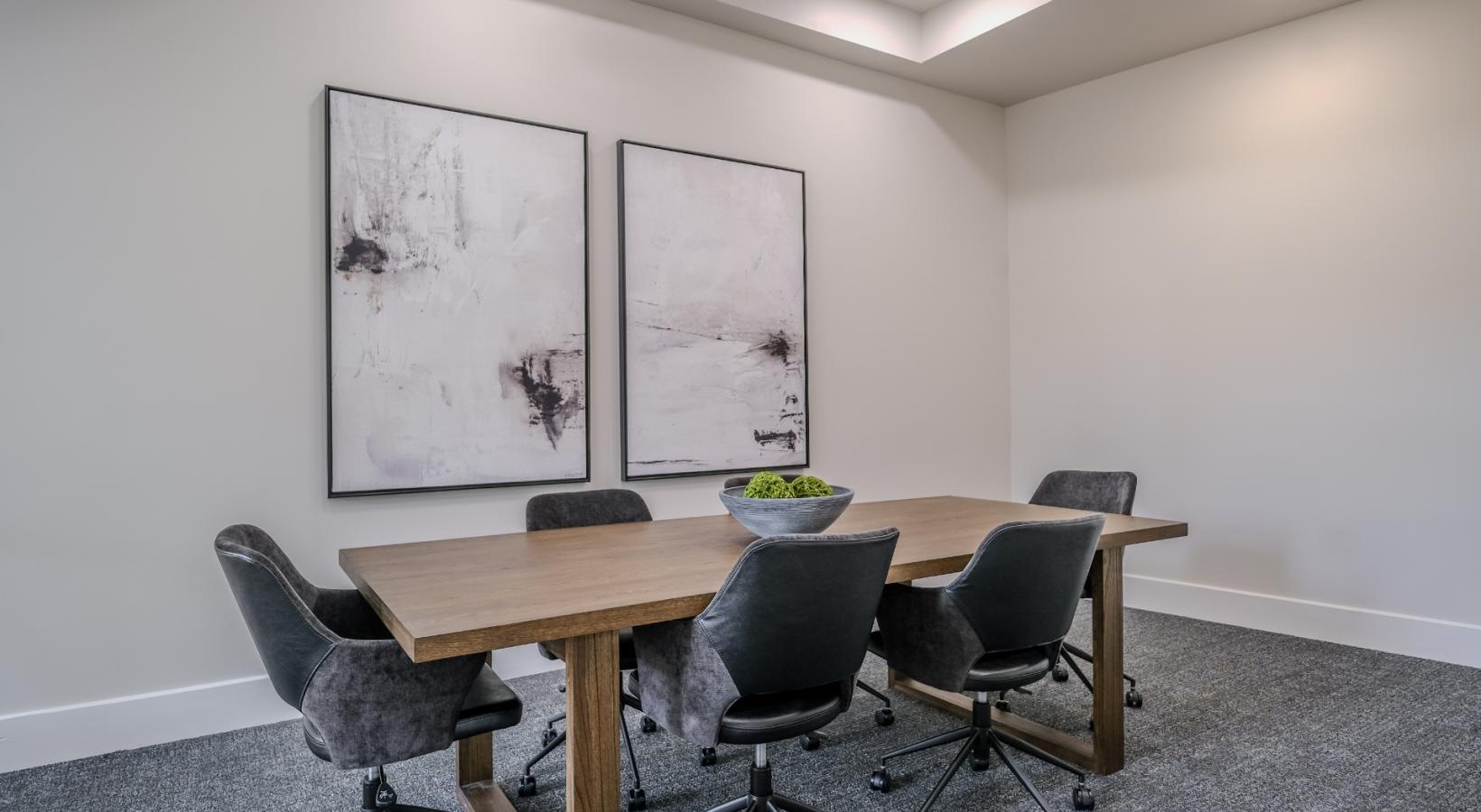 Settle into comfort at The Allure a conference room with a table and chairs