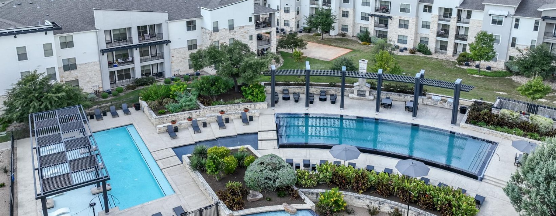 a pool in a courtyard with buildings in the background