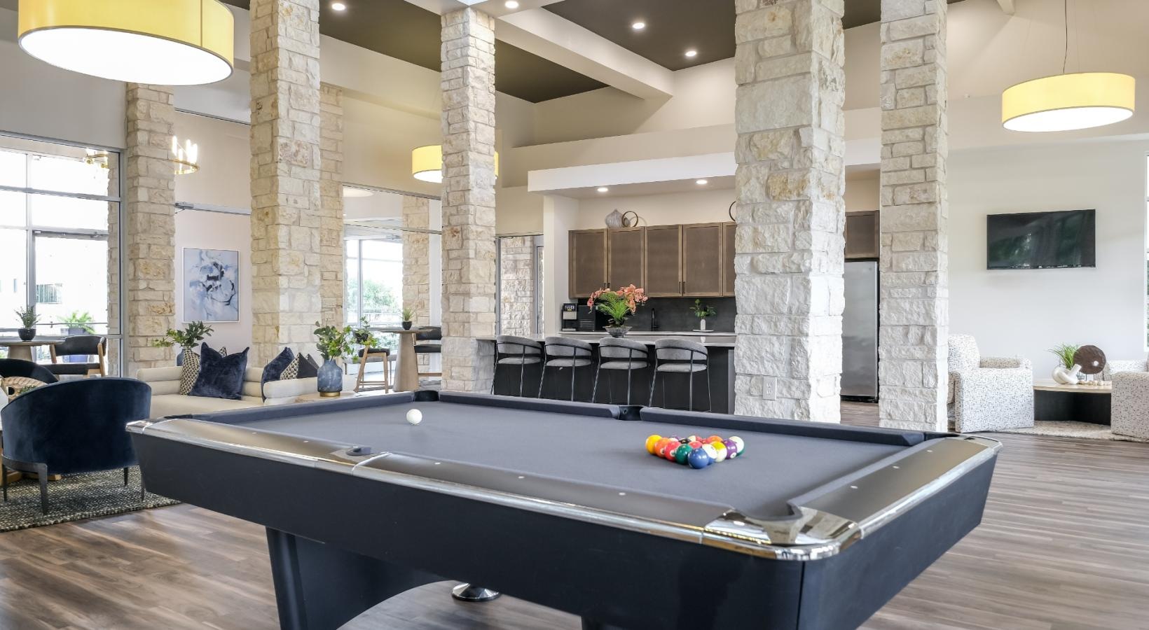 Take advantage of all The Allure has to offer a large room with a pool table and chairs