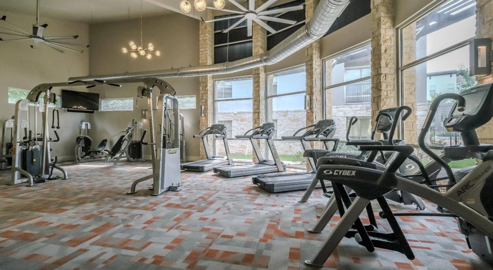 State-of-the-art amenities a room with treadmills and treadmills
