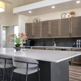 Enjoy our resident-only features a kitchen with a bar and chairs