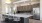 a kitchen with a bar and chairs