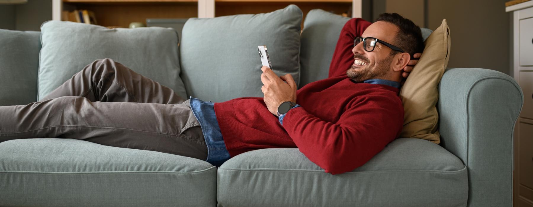 a person sitting on a couch playing video games
