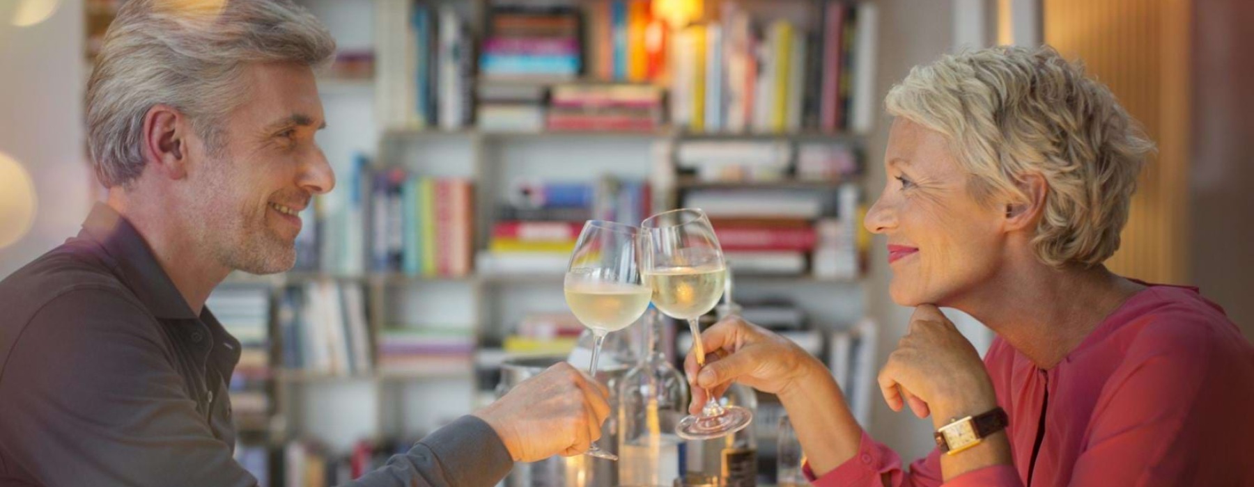 a man and a woman holding wine glasses