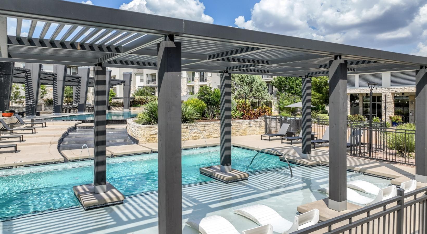 Shimmering resort-style pool a pool with a covered patio